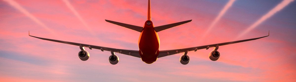 Airplane flying in the sky at sunset with vapor trails
